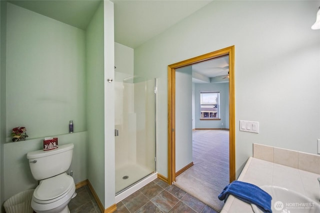 8151 E Seaview Dr, Port Orchard, WA 98366 - full bath featuring a shower stall, baseboards, toilet, stone finish floors, and ceiling fan