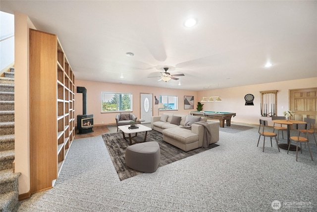 8151 E Seaview Dr, Port Orchard, WA 98366 - living area with a wood stove, stairway, baseboards, a ceiling fan, and billiards table