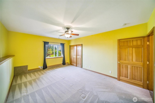 8151 E Seaview Dr, Port Orchard, WA 98366 - unfurnished bedroom with baseboards, carpet, and a ceiling fan