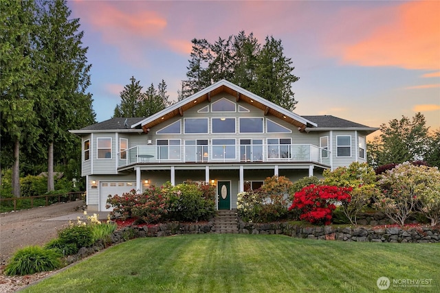 8151 E Seaview Dr, Port Orchard, WA 98366 - view of front of property featuring asphalt driveway, a front yard, a balcony, and an attached garage