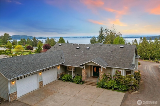8151 E Seaview Dr, Port Orchard, WA 98366 - view of front facade with roof with shingles, a garage, and stone siding
