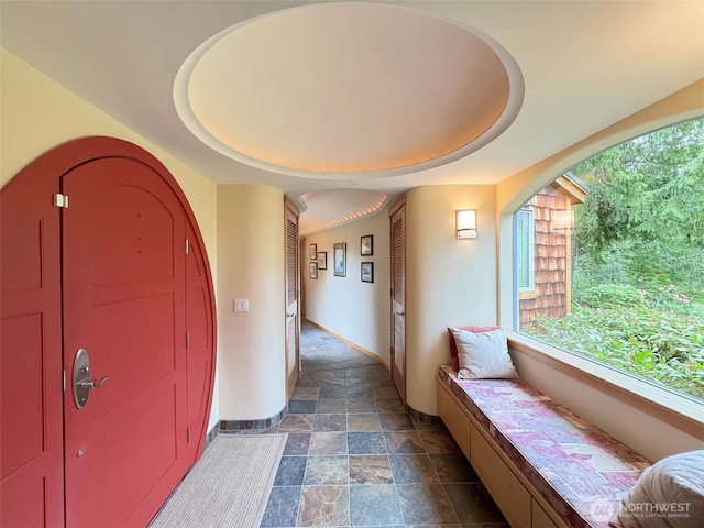 2734 Blue Mountain Rd, Sequim, WA 98362 - entryway featuring dark stone finish flooring, baseboards, and a raised ceiling