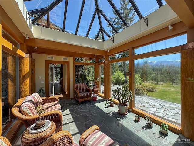 2734 Blue Mountain Rd, Sequim, WA 98362 - sunroom with stone flooring, a high ceiling, and a skylight
