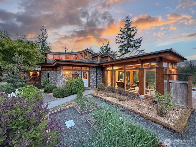 2734 Blue Mountain Rd, Sequim, WA 98362 - rear view of house featuring stone siding and a sunroom