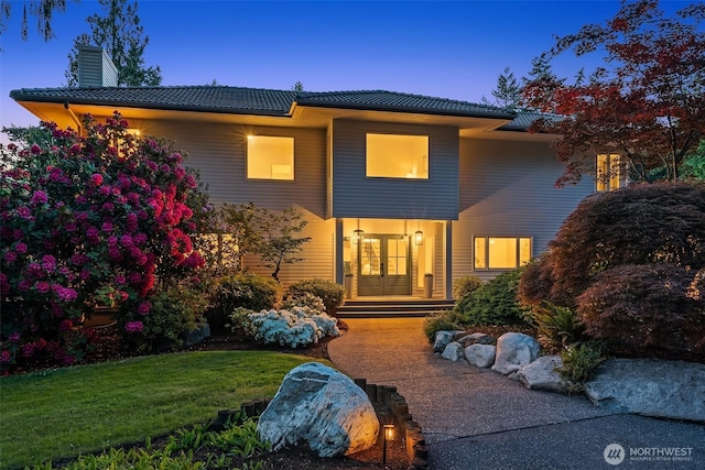12909 Spanaway Loop Rd S, Tacoma, WA 98444 - view of front facade with a chimney, a yard, and french doors