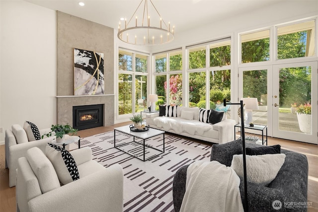 12909 Spanaway Loop Rd S, Tacoma, WA 98444 - living room featuring a chandelier, recessed lighting, a premium fireplace, and wood finished floors