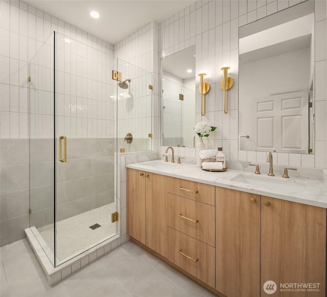 12909 Spanaway Loop Rd S, Tacoma, WA 98444 - bathroom with double vanity, a shower stall, tile patterned flooring, and tile walls