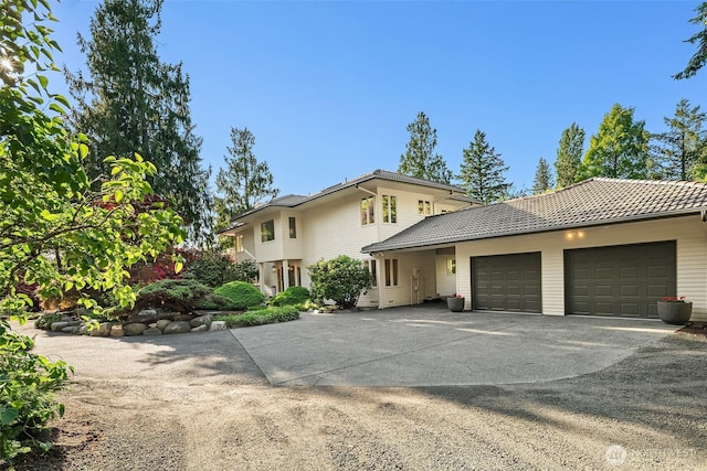 12909 Spanaway Loop Rd S, Tacoma, WA 98444 - view of front of property featuring a garage, driveway, and a tiled roof