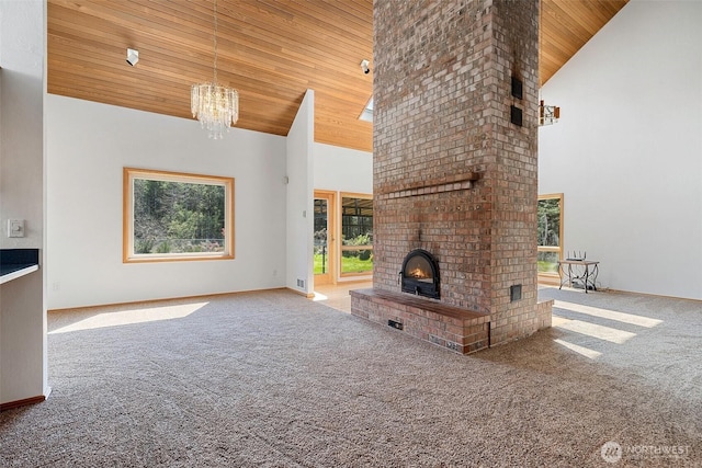 145 E Falcon Ct, Shelton, WA 98584 - unfurnished living room with high vaulted ceiling, carpet flooring, wood ceiling, a chandelier, and a fireplace