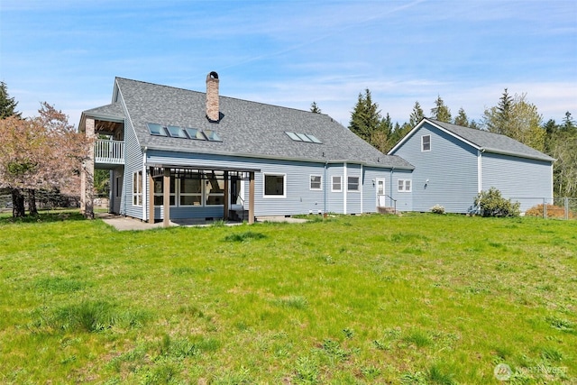 145 E Falcon Ct, Shelton, WA 98584 - rear view of house featuring a balcony, a chimney, a lawn, and a shingled roof