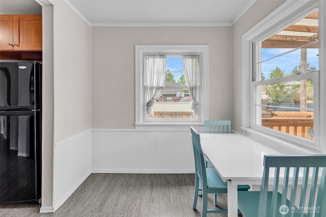411 7th St SE, Auburn, WA 98002 - dining space with wood finished floors, ornamental molding, a wainscoted wall, and baseboards