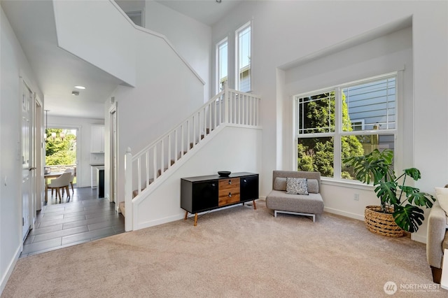 4844 Bridgeport Pl, Mukilteo, WA 98285 - living area with carpet floors, stairway, baseboards, and a towering ceiling
