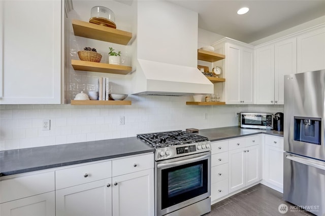 4844 Bridgeport Pl, Mukilteo, WA 98285 - kitchen with open shelves, appliances with stainless steel finishes, dark countertops, premium range hood, and recessed lighting