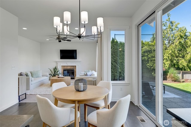 4844 Bridgeport Pl, Mukilteo, WA 98285 - dining area featuring a chandelier, recessed lighting, a premium fireplace, and baseboards