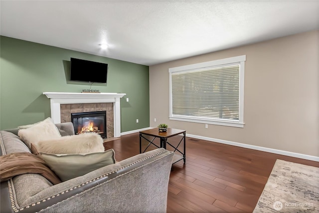 20003 13th Avenue Ct E, Spanaway, WA 98387 - living area with a tile fireplace, baseboards, and dark wood-style flooring