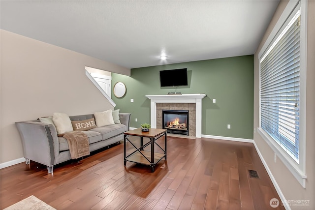 20003 13th Avenue Ct E, Spanaway, WA 98387 - living room with a tiled fireplace, wood finished floors, and baseboards