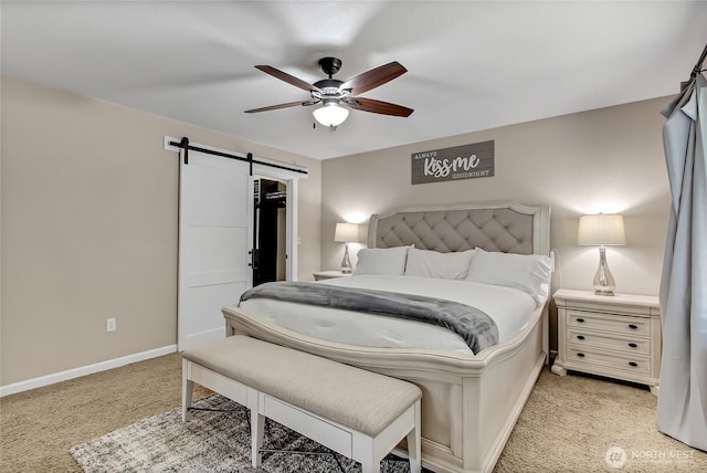 20003 13th Avenue Ct E, Spanaway, WA 98387 - bedroom with a barn door, light colored carpet, a walk in closet, baseboards, and a ceiling fan