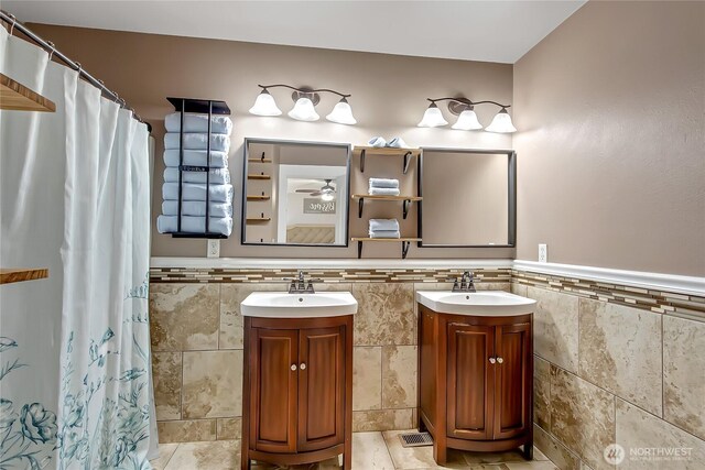 20003 13th Avenue Ct E, Spanaway, WA 98387 - full bathroom featuring tile walls, vanity, a wainscoted wall, and curtained shower