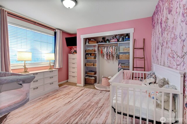 20003 13th Avenue Ct E, Spanaway, WA 98387 - bedroom with light wood-type flooring, a closet, and baseboards
