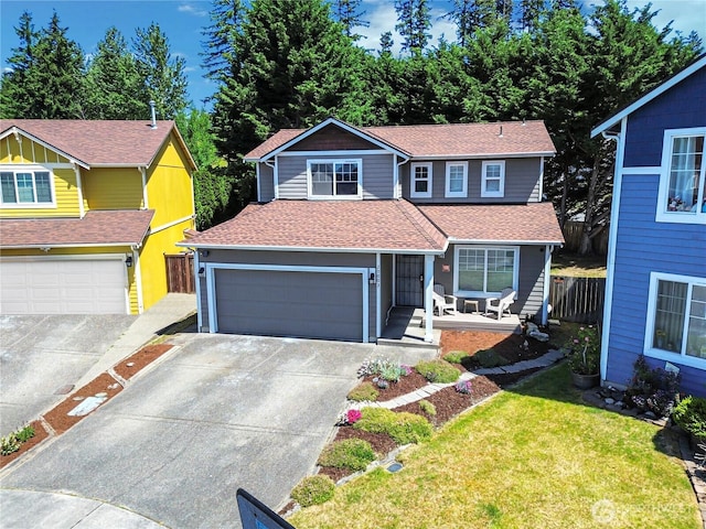 20003 13th Avenue Ct E, Spanaway, WA 98387 - traditional home with concrete driveway, a shingled roof, an attached garage, and a porch