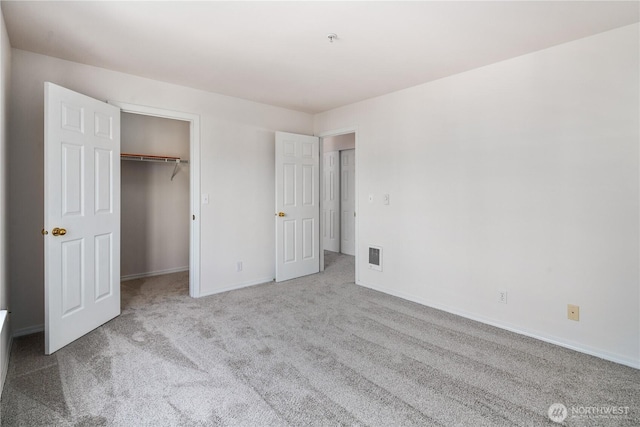 1733 NW 59th St Unit 201, Seattle, WA 98107 - unfurnished bedroom with carpet flooring, baseboards, a spacious closet, and a closet