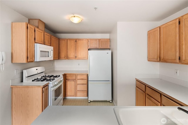 1733 NW 59th St Unit 201, Seattle, WA 98107 - kitchen with white appliances, light countertops, and a sink