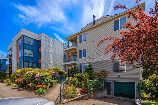 1733 NW 59th St Unit 201, Seattle, WA 98107 - view of building exterior with an attached garage