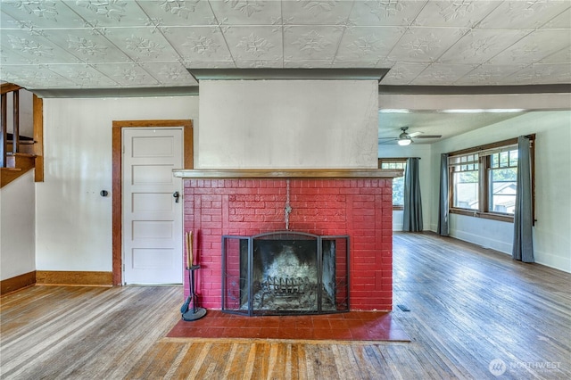 2150 N Callow Ave, Bremerton, WA 98312 - detailed view of baseboards, wood finished floors, a brick fireplace, and an ornate ceiling