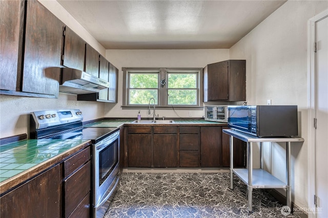2150 N Callow Ave, Bremerton, WA 98312 - kitchen with stainless steel range with electric cooktop, black microwave, a sink, tile countertops, and dark brown cabinets
