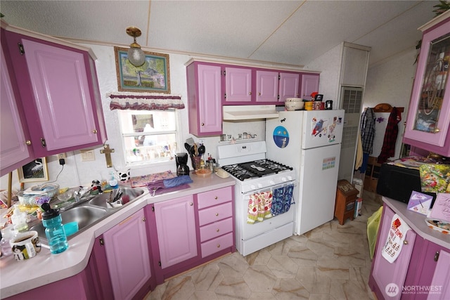 1710 254th St, Ocean Park, WA 98640 - kitchen featuring white appliances, under cabinet range hood, light countertops, a sink, and hanging light fixtures