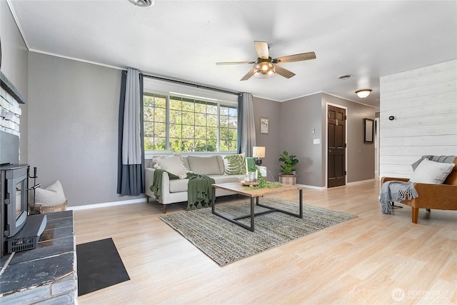 1669 Grandview Pl, Ferndale, WA 98248 - living room with wood finished floors, baseboards, a ceiling fan, a wood stove, and crown molding