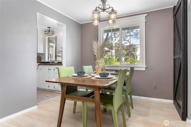 1669 Grandview Pl, Ferndale, WA 98248 - dining area with light wood-style flooring, a chandelier, crown molding, and baseboards