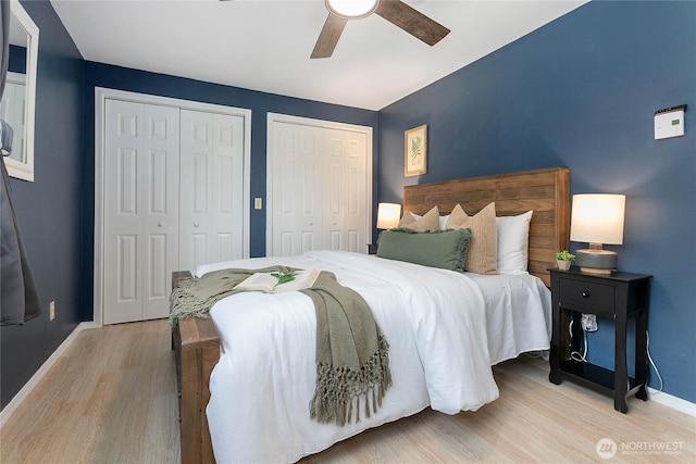 1669 Grandview Pl, Ferndale, WA 98248 - bedroom featuring two closets, wood finished floors, baseboards, and a ceiling fan