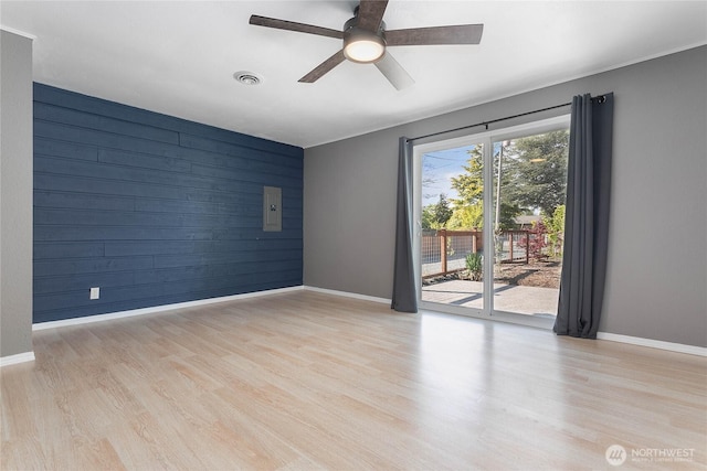 1669 Grandview Pl, Ferndale, WA 98248 - unfurnished room featuring baseboards, light wood finished floors, a ceiling fan, and wooden walls