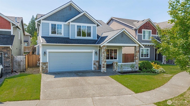 11724 1st Pl SE, Lake Stevens, WA 98258 - craftsman-style house with stone siding, concrete driveway, a garage, a porch, and roof with shingles
