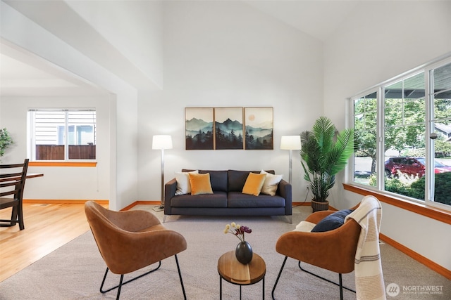 11724 1st Pl SE, Lake Stevens, WA 98258 - living area featuring baseboards, a towering ceiling, and wood finished floors