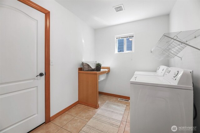 11724 1st Pl SE, Lake Stevens, WA 98258 - laundry area featuring independent washer and dryer, light tile patterned floors, and baseboards