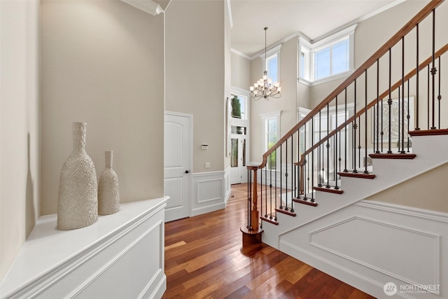4105 215th St SE, Bothell, WA 98021 - foyer entrance featuring a towering ceiling, crown molding, wood finished floors, a wainscoted wall, and stairway