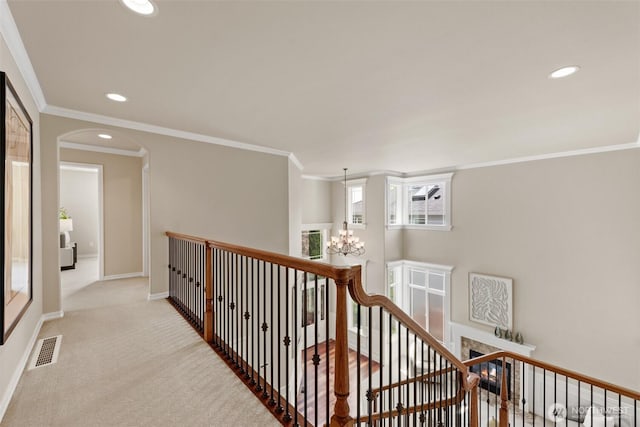 4105 215th St SE, Bothell, WA 98021 - hall featuring an upstairs landing, a chandelier, crown molding, arched walkways, and recessed lighting