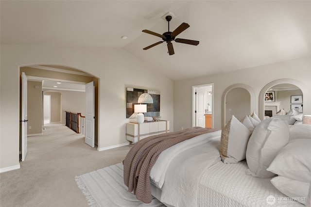 4105 215th St SE, Bothell, WA 98021 - bedroom featuring arched walkways, lofted ceiling, light colored carpet, baseboards, and ensuite bath