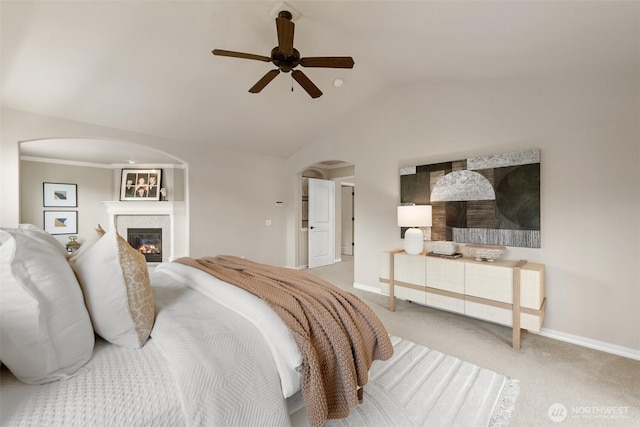 4105 215th St SE, Bothell, WA 98021 - carpeted bedroom with arched walkways, vaulted ceiling, baseboards, a glass covered fireplace, and ceiling fan