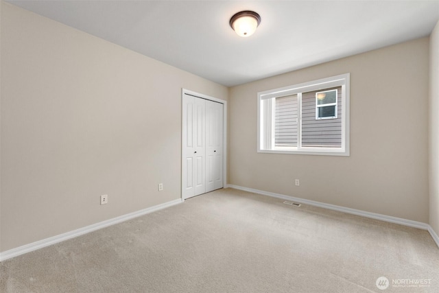 4105 215th St SE, Bothell, WA 98021 - unfurnished bedroom featuring light carpet, baseboards, and a closet