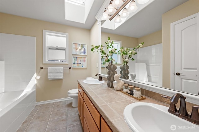 4105 215th St SE, Bothell, WA 98021 - bathroom featuring double vanity, toilet, baseboards, tile patterned flooring, and a skylight