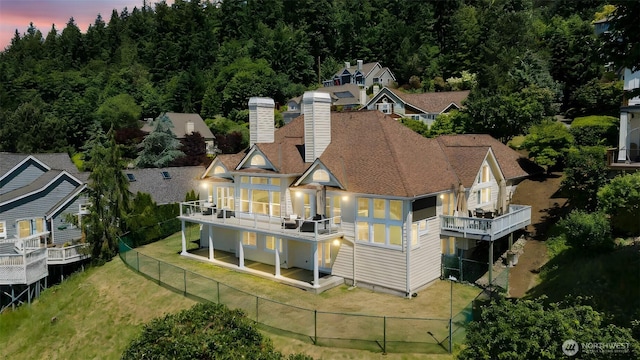 1653 204th Ave NE, Sammamish, WA 98074 - rear view of house featuring a fenced backyard, a chimney, and a balcony