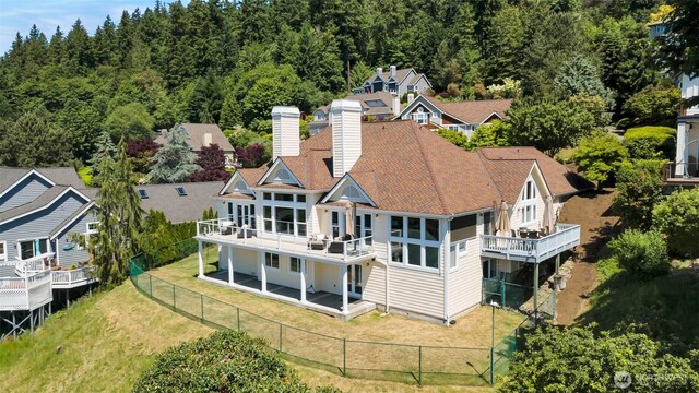 1653 204th Ave NE, Sammamish, WA 98074 - back of property featuring a chimney, a wooden deck, and a forest view