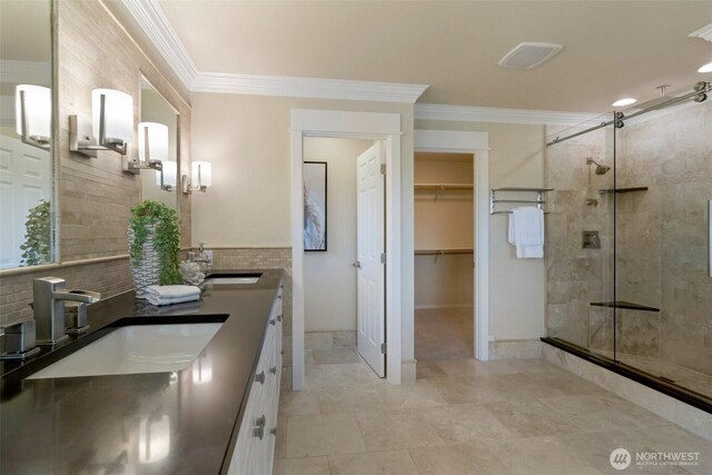 1653 204th Ave NE, Sammamish, WA 98074 - bathroom featuring ornamental molding, a stall shower, backsplash, double vanity, and a spacious closet