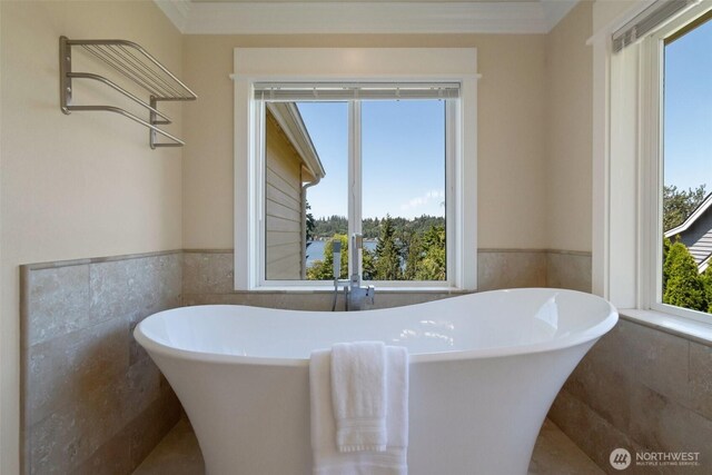 1653 204th Ave NE, Sammamish, WA 98074 - bathroom featuring tile walls, a soaking tub, wainscoting, and ornamental molding