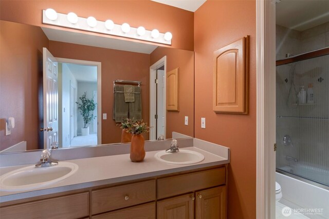1653 204th Ave NE, Sammamish, WA 98074 - full bath with double vanity, toilet, and bath / shower combo with glass door