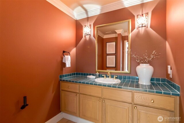 1653 204th Ave NE, Sammamish, WA 98074 - bathroom featuring crown molding, vanity, and baseboards