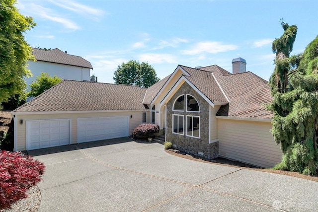 1653 204th Ave NE, Sammamish, WA 98074 - view of front of home with stone siding, driveway, a chimney, a garage, and roof with shingles